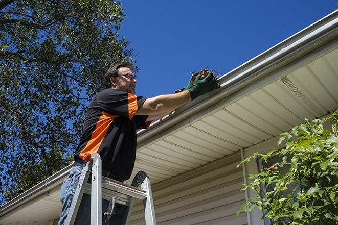 home maintenance worker repairing a leaky gutter in Chatham, NJ